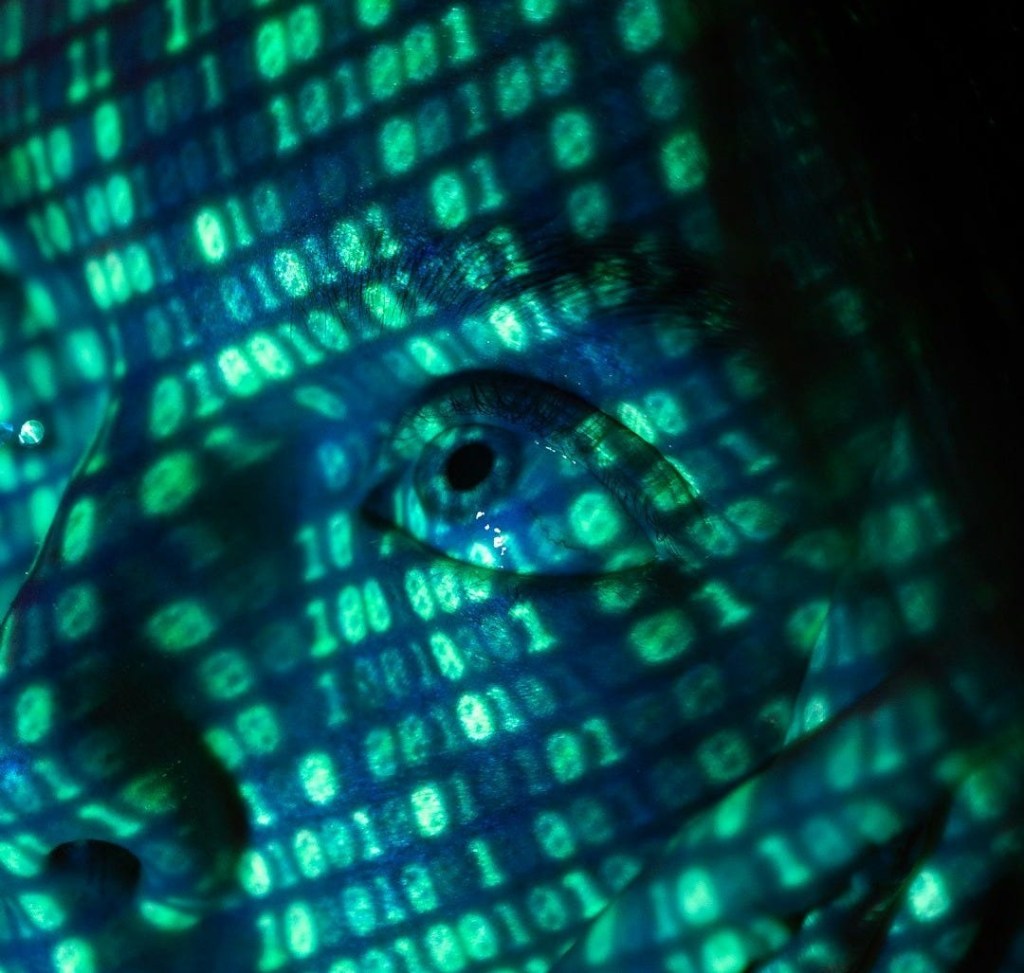 a close up of a person's face in front of a computer screen